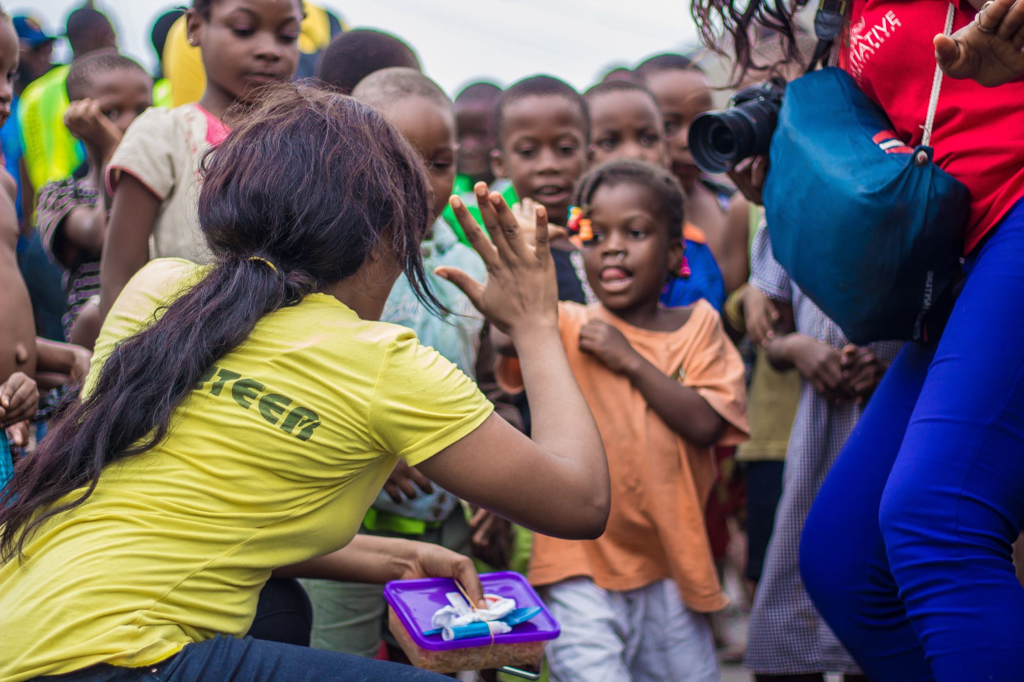 A volunteer connecting with children during a community outreach event
